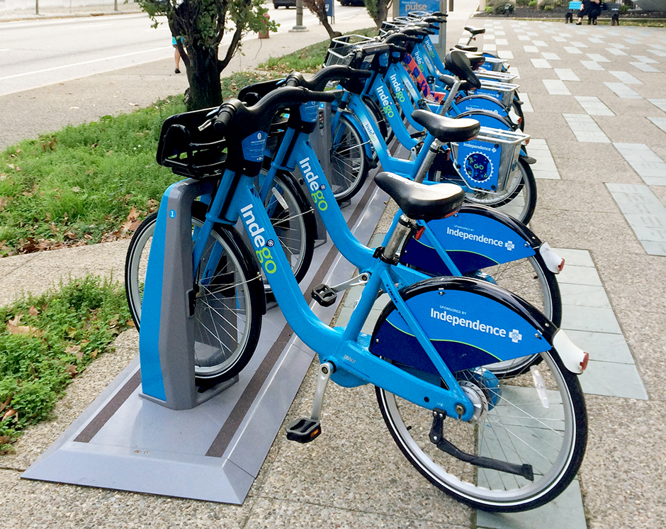 A row of Indego bikes in a docking station