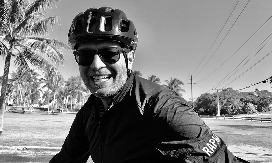 A black and white photo of DVRPC staff member Jason Crouch wearing a bicycle helmet