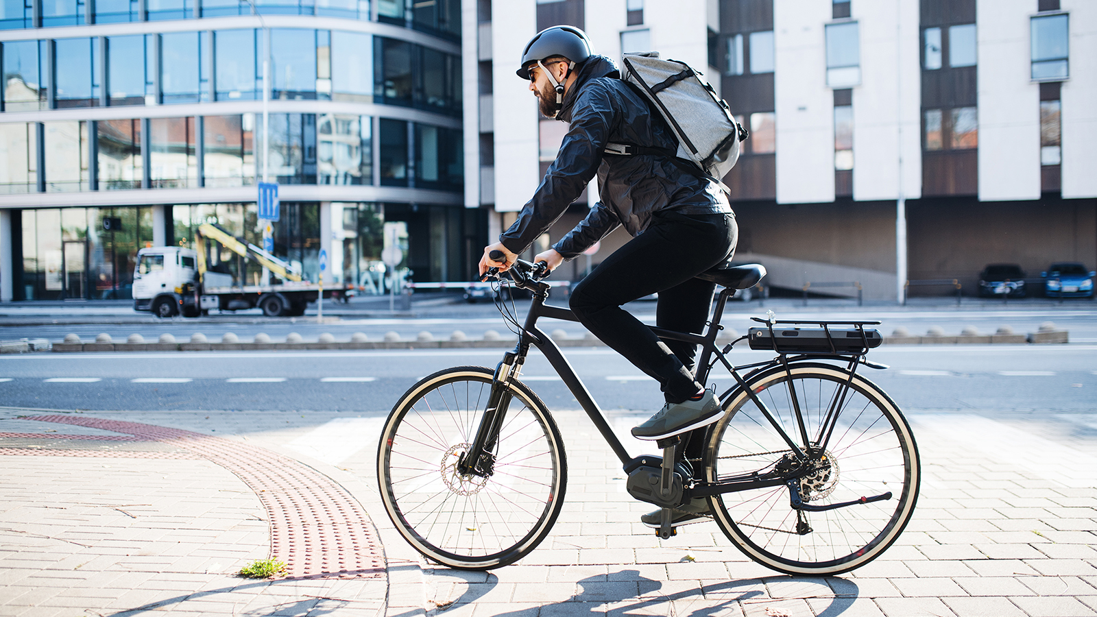 A person riding an e-bike on a city street