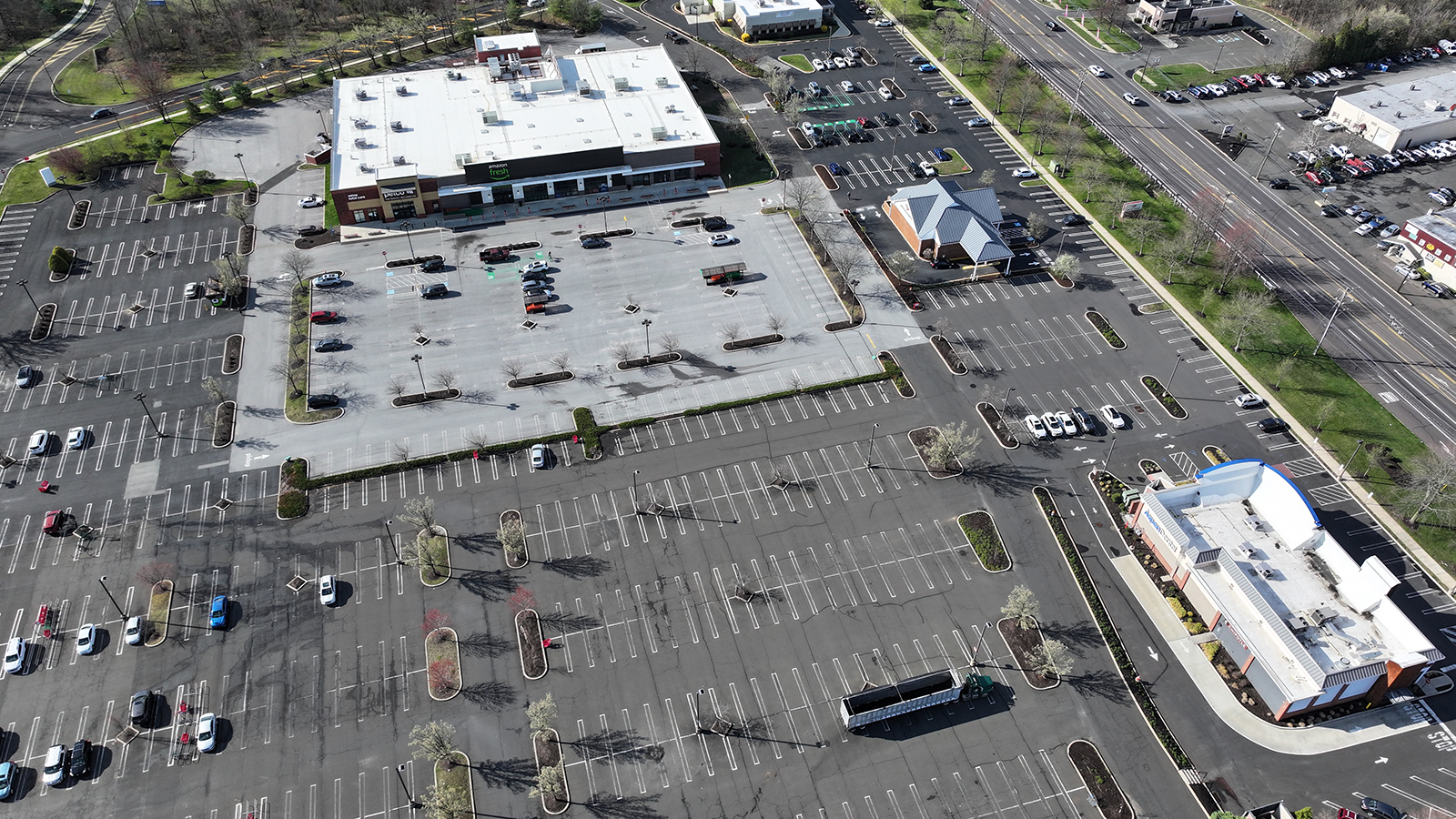An aerial photo of parking lots surrounding a shopping center
